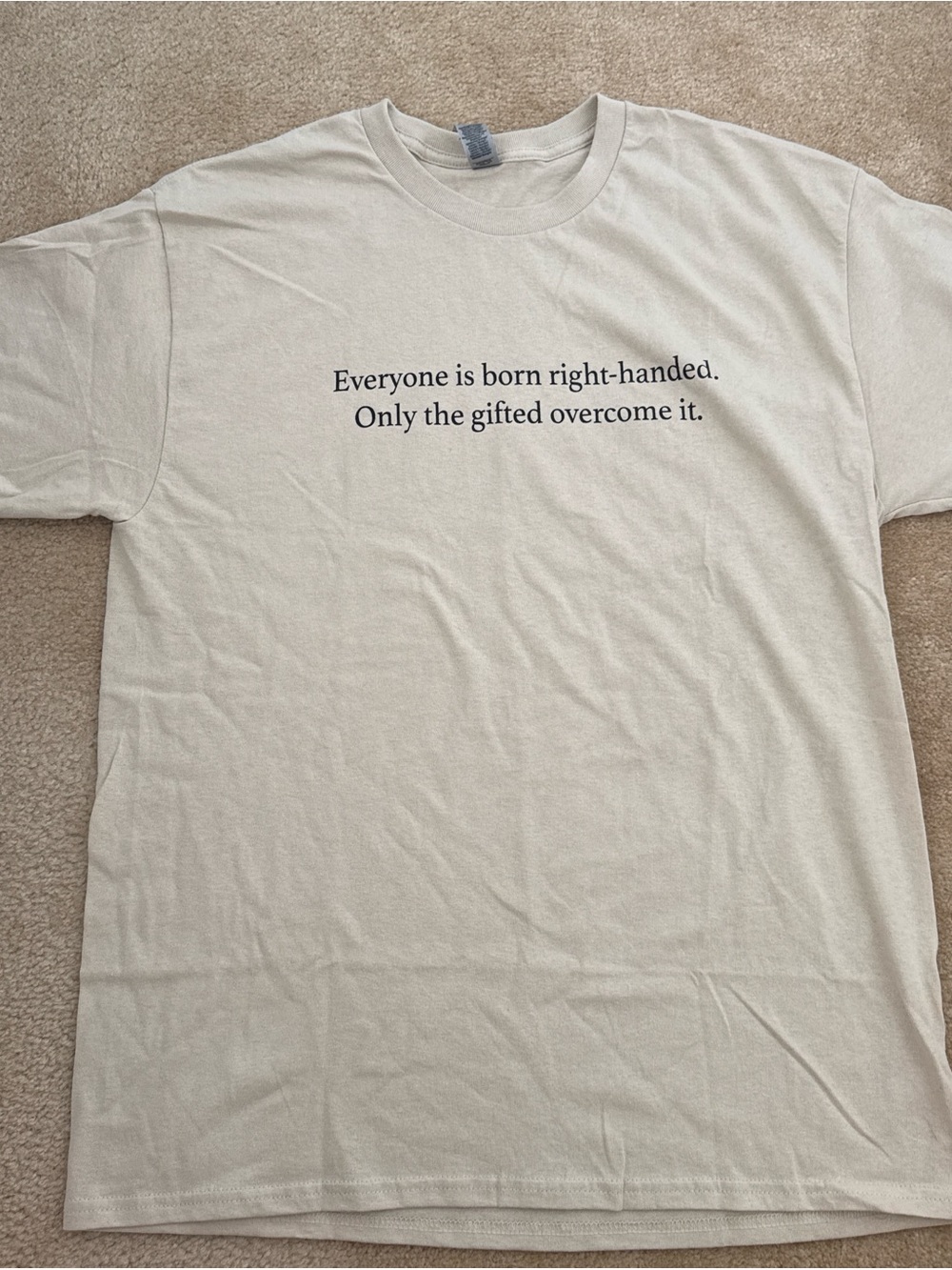 Gildan Cream Short-Sleeve Tee with Black Text "Everyone is born right-handed"